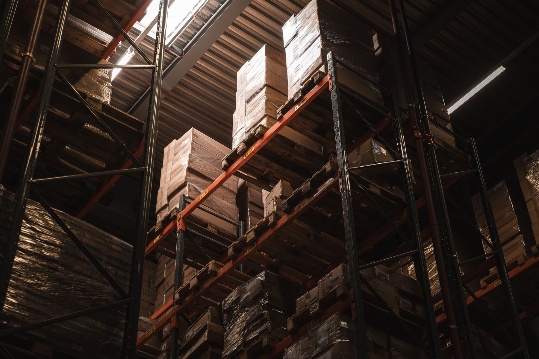 Warehouse racks with palletised inventory staged for fulfilment